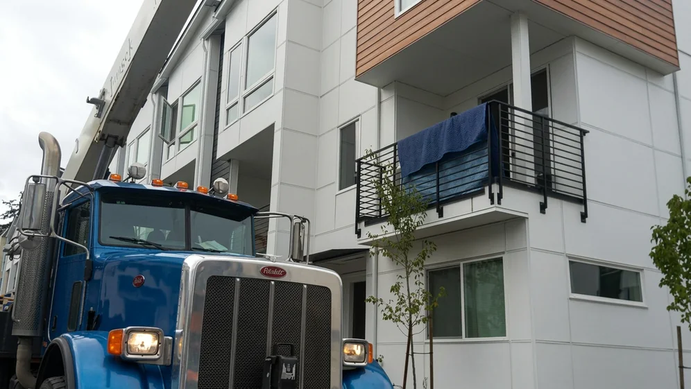 Movers preparing household items for transport